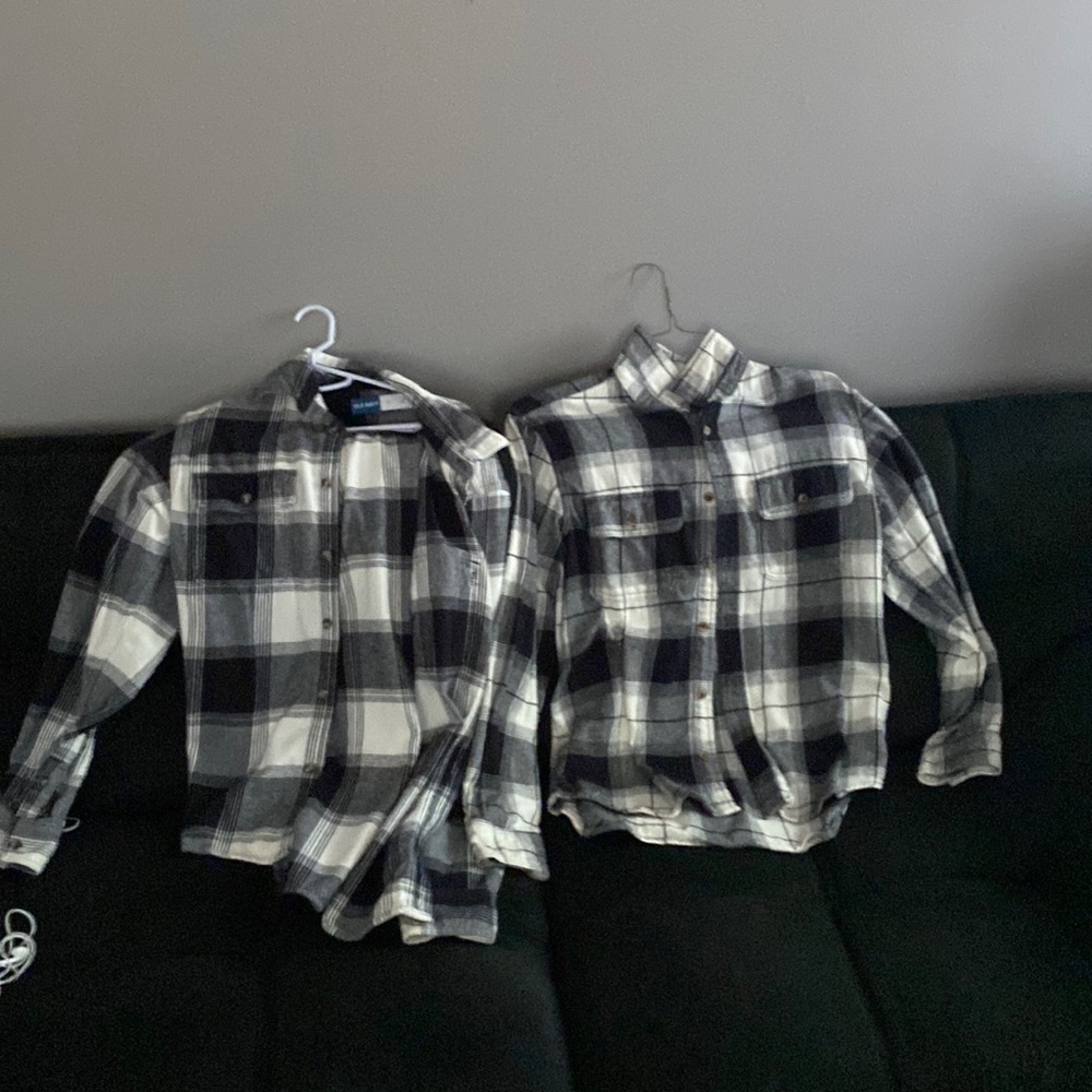 two men’s medium, gray, black and white flannel shirts.